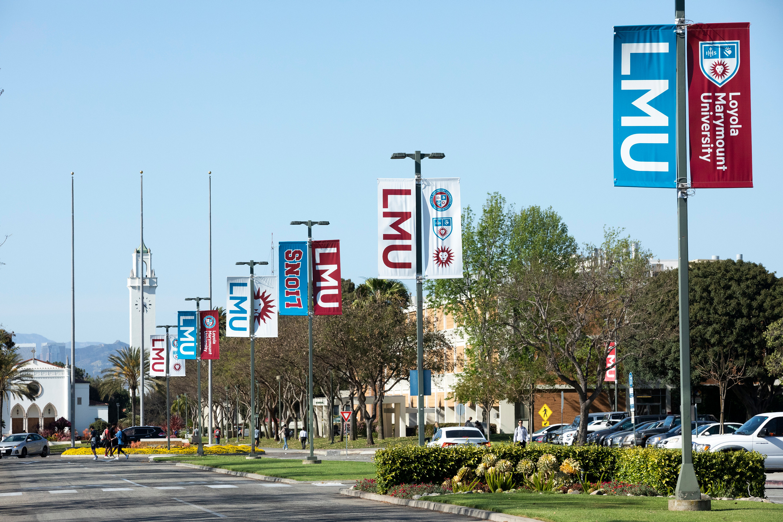several LMU signs on poles in a row